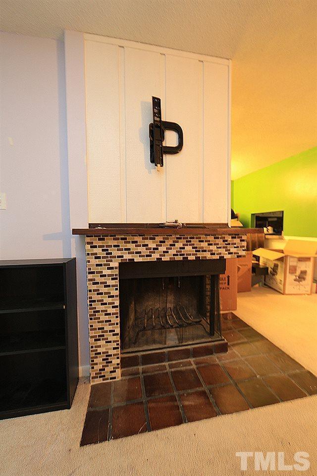 4100 Five Oaks Drive, Unit 49 Durham, NC 27707 - Photo 4 of 23 a living room with a fireplace and a wooden floor