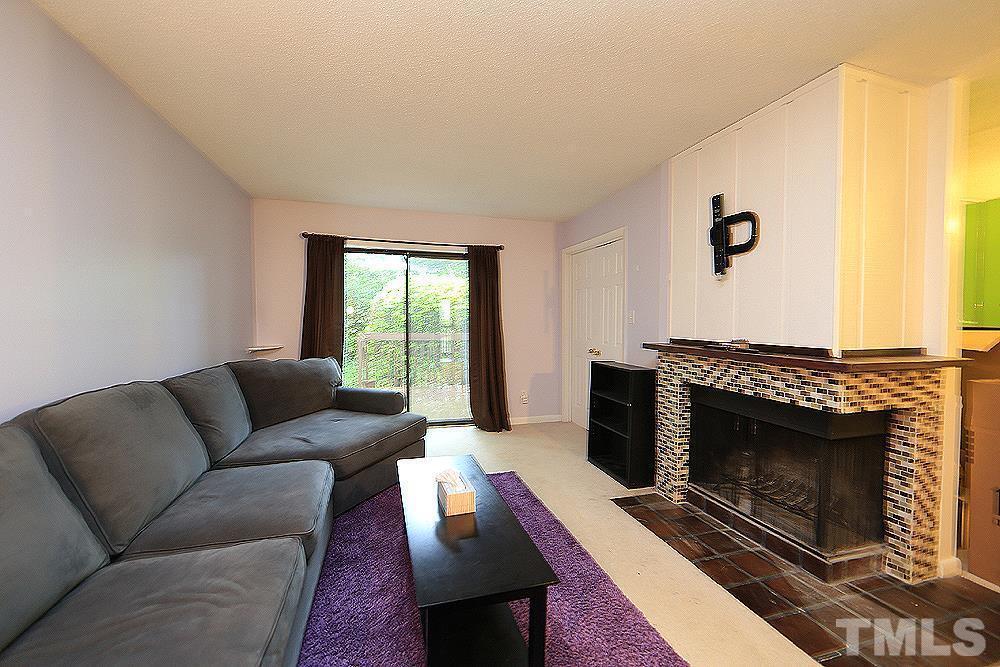 4100 Five Oaks Drive, Unit 49 Durham, NC 27707 - Photo 6 of 23 a living room with furniture and a fireplace