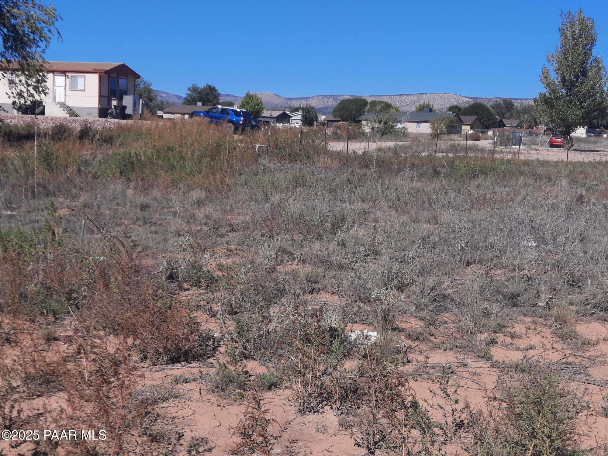 24255 North Riviera Avenue Paulden, AZ 86334 - Photo 3 of 5 a view of a dry yard with trees