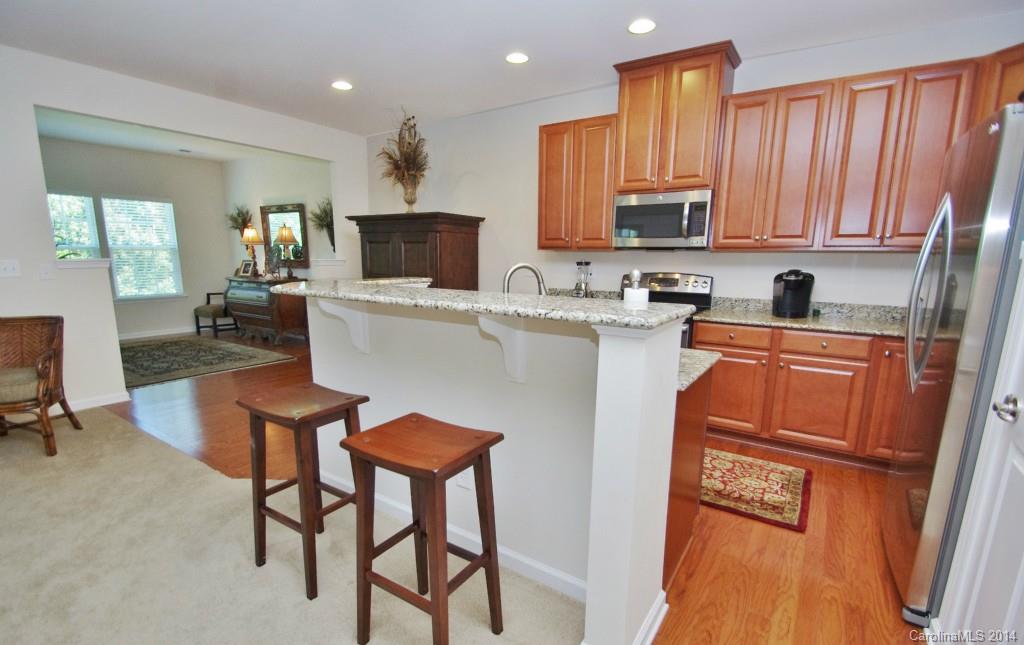 3008 Fallondale Road Waxhaw, NC 28173 - Photo 5 of 23 a kitchen with a table chairs refrigerator and microwave