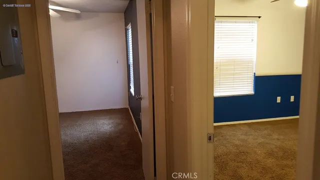 a view of an empty room with empty shelves