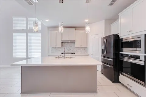 a view of a livingroom with a ceiling fan and window