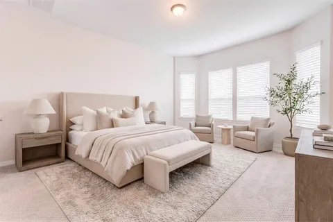 a bedroom with bed and window