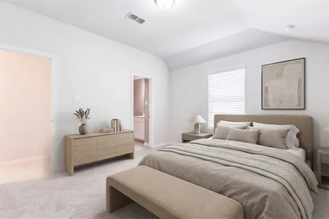 a bedroom with a bed and a lamp