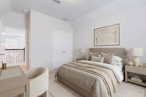 a spacious bedroom with a bed and a couch