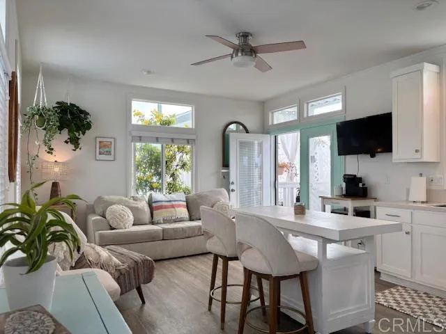 a living room with furniture a window and a flat screen tv