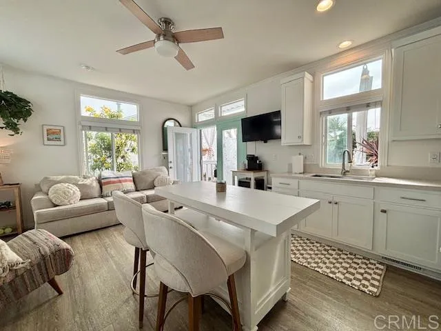 a living room with furniture a flat screen tv and a window