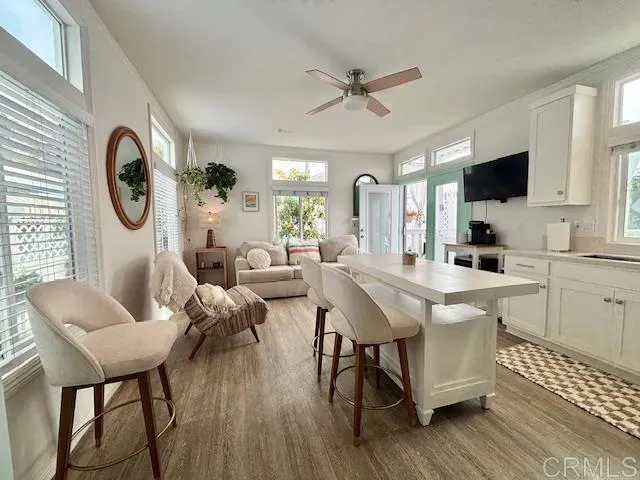 a living room with furniture a flat screen tv and a window