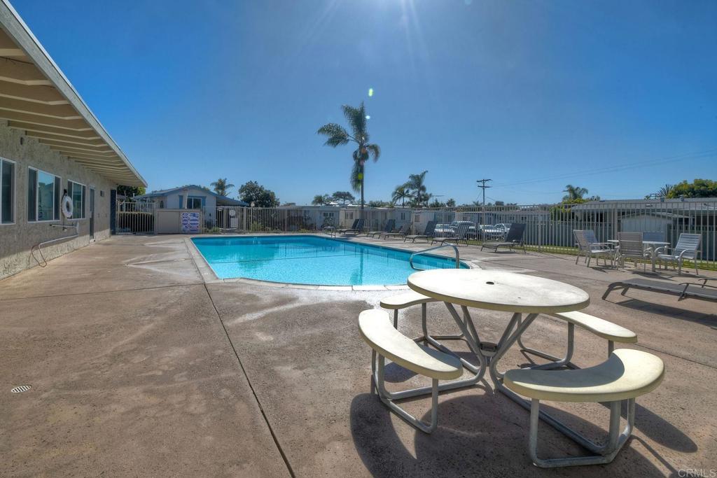 699 North Vulcan Avenue, Unit 80 Encinitas, CA 92024 - Photo 27 of 27 a view of a backyard with table and chairs