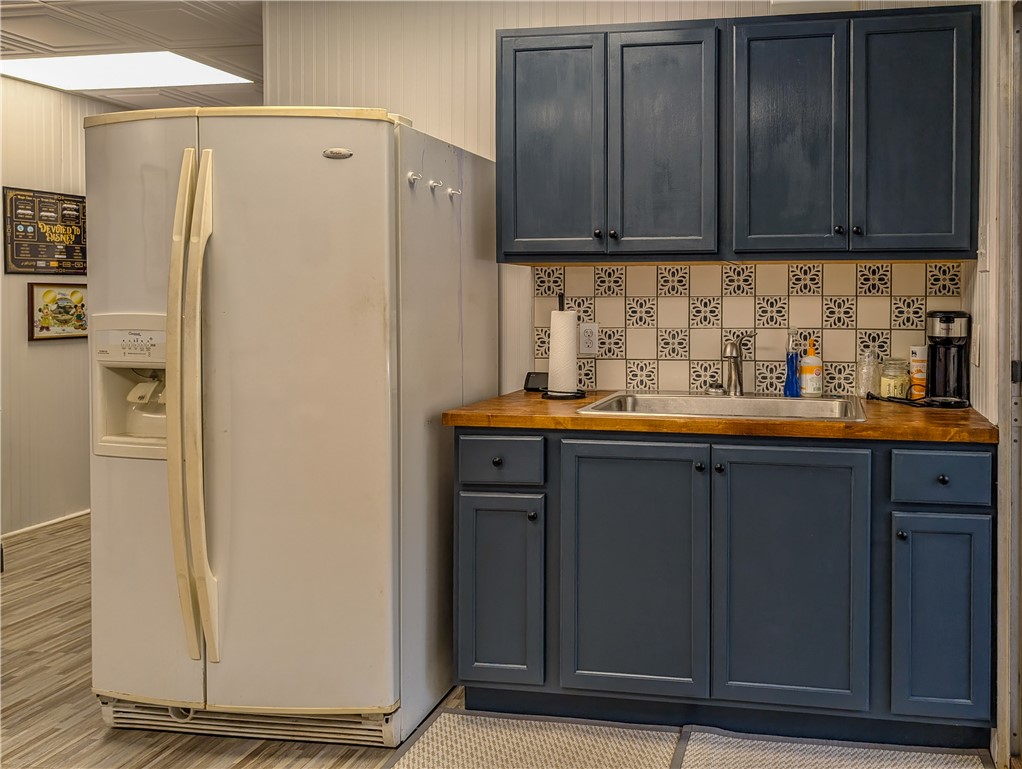 620 Seminole Point Road Fair Play, SC 29643 - Photo 41 of 50 Rich blue cabinetry and warm wood countertops create a charming workspace alongside a convenient kitchenette setup.