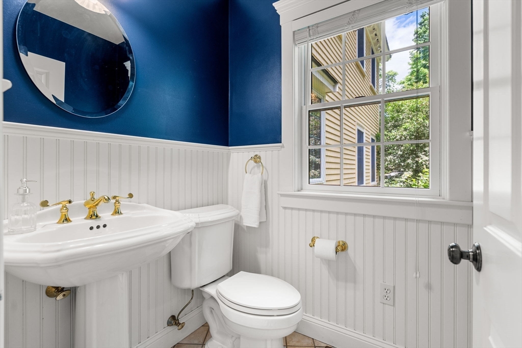 338 Pond Street Dunstable, MA 01827 - Photo 16 of 42 a bathroom with a sink a toilet and a mirror