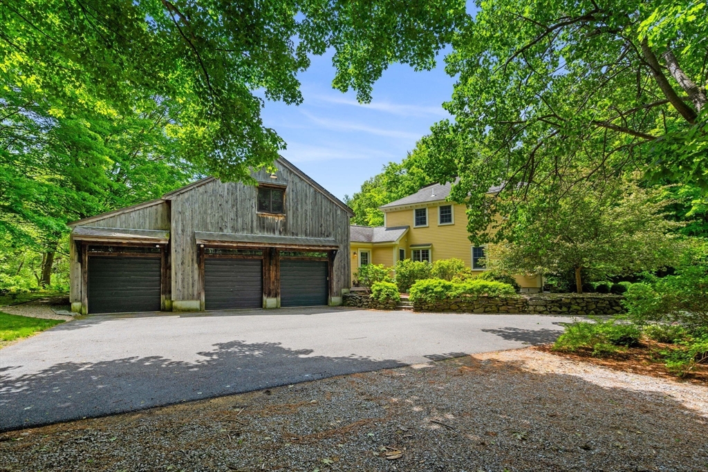 338 Pond Street Dunstable, MA 01827 - Photo 2 of 42 a front view of a house with a yard and garage