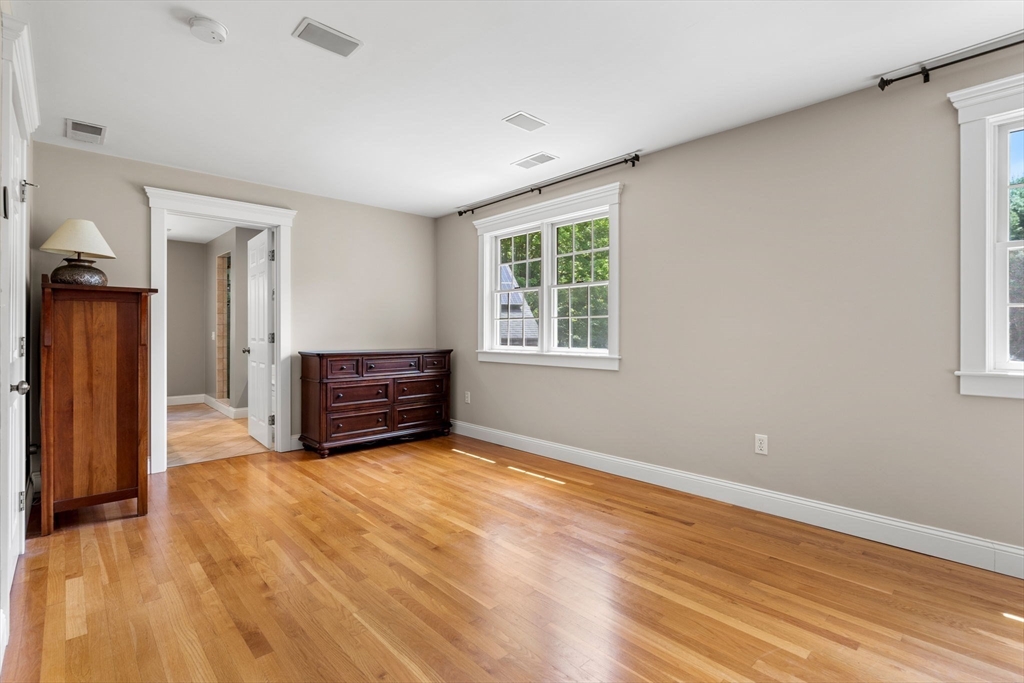 338 Pond Street Dunstable, MA 01827 - Photo 23 of 42 a view of an empty room with a window and wooden floor