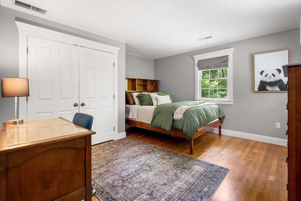 338 Pond Street Dunstable, MA 01827 - Photo 30 of 42 a bedroom with a bed and wooden floor