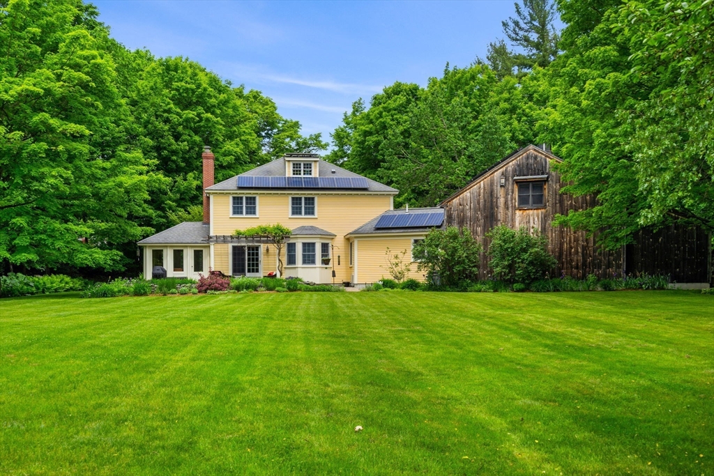 338 Pond Street Dunstable, MA 01827 - Photo 3 of 42 a front view of a house with a garden