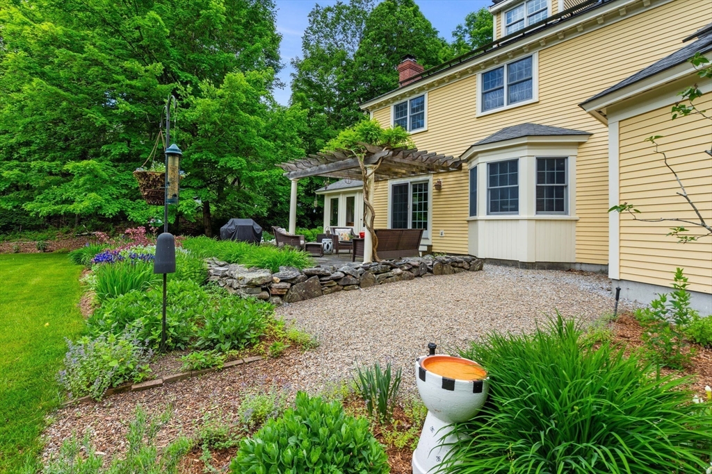 338 Pond Street Dunstable, MA 01827 - Photo 40 of 42 a front view of house with yard and outdoor seating