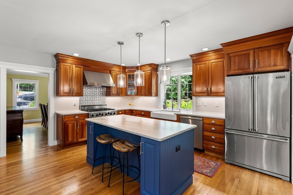 338 Pond Street Dunstable, MA 01827 - Photo 6 of 42 a kitchen with stainless steel appliances granite countertop a refrigerator a sink dishwasher a stove and a wooden floor