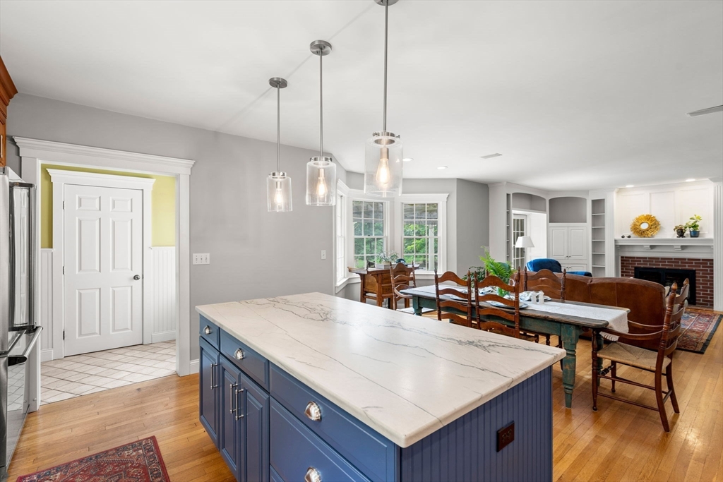 338 Pond Street Dunstable, MA 01827 - Photo 7 of 42 a view of a dining room and livingroom with furniture wooden floor a chandelier
