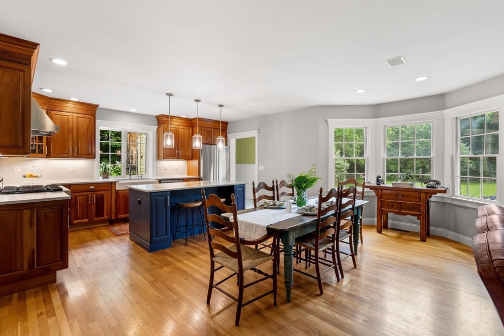 338 Pond Street Dunstable, MA 01827 - Photo 8 of 42 a dining room with a wooden table and chairs