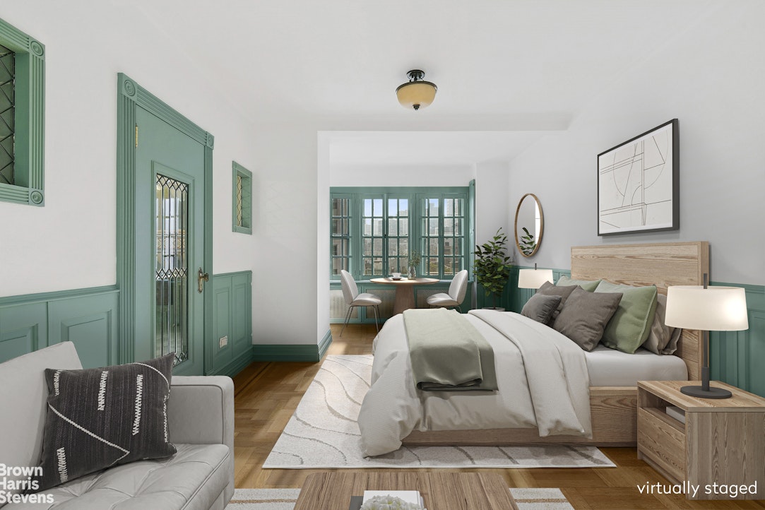 a bedroom with furniture and a large window