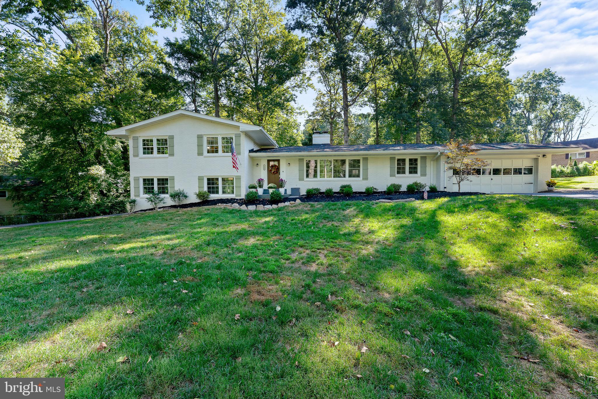 2425 Hunter Mill Road Vienna, VA 22181 - Photo 1 of 28 a view of a house with a yard and sitting area