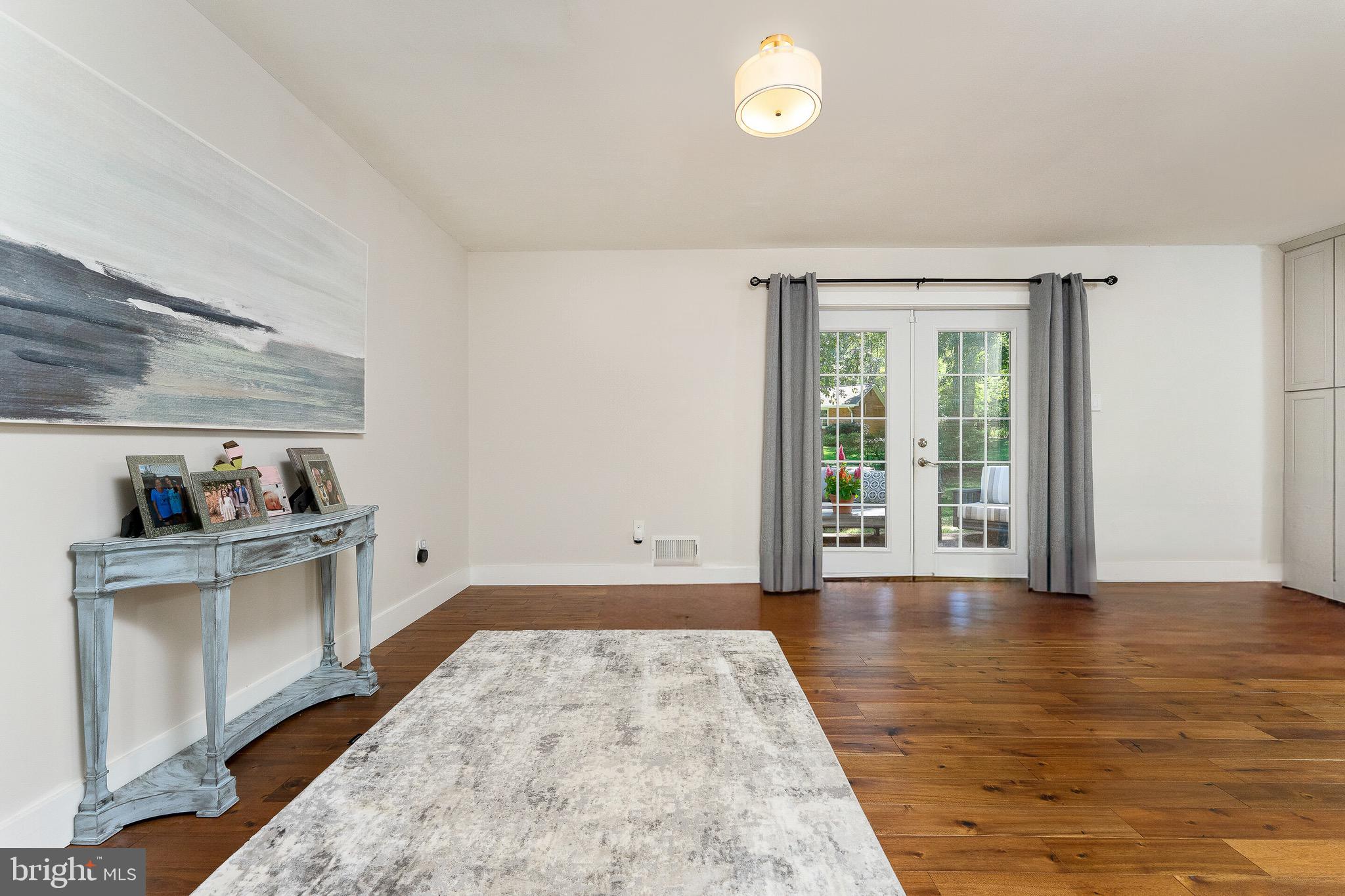 2425 Hunter Mill Road Vienna, VA 22181 - Photo 11 of 28 an empty room with wooden floor and a window