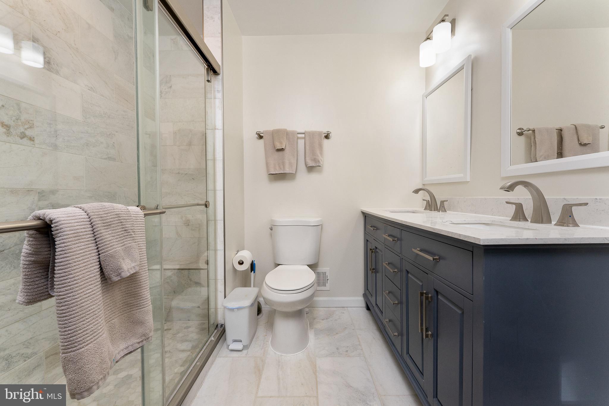 2425 Hunter Mill Road Vienna, VA 22181 - Photo 15 of 28 a bathroom with a sink toilet and shower