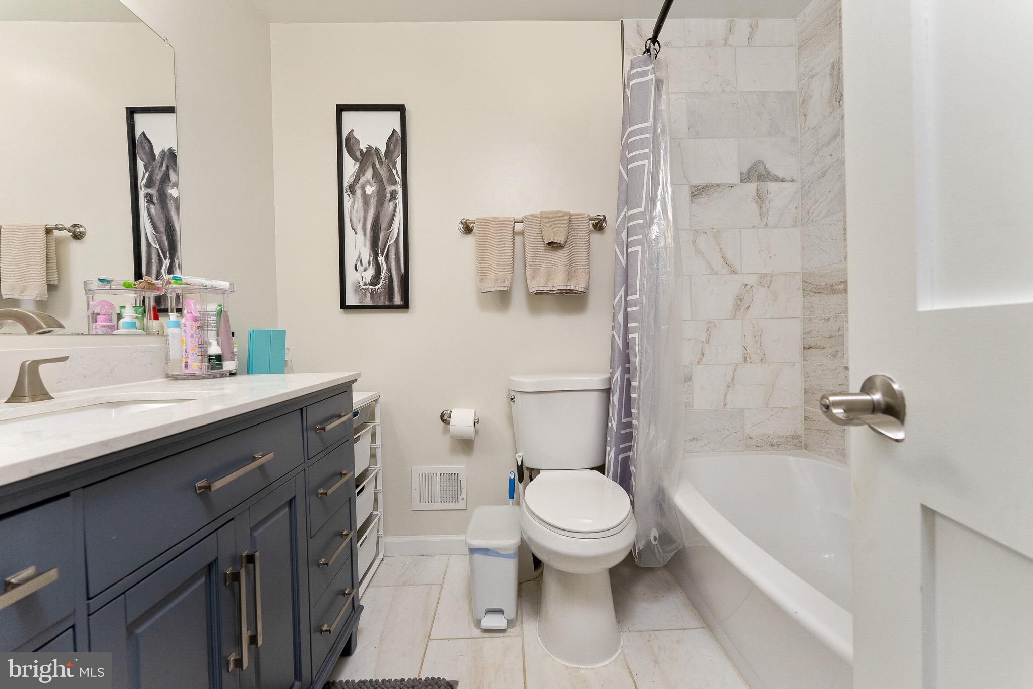 2425 Hunter Mill Road Vienna, VA 22181 - Photo 17 of 28 a bathroom with a sink a toilet and shower