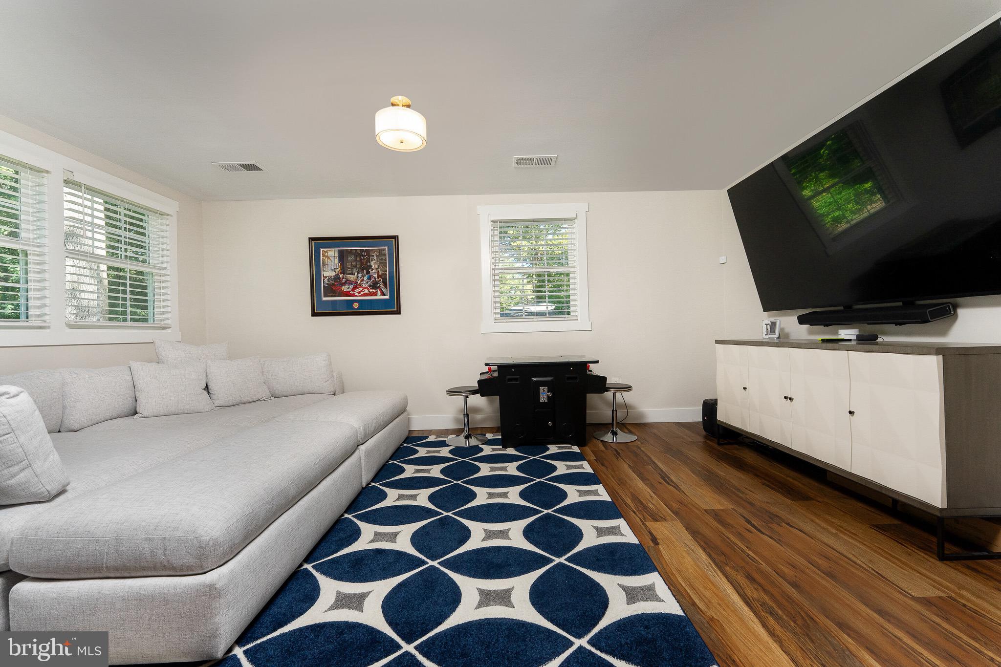 2425 Hunter Mill Road Vienna, VA 22181 - Photo 20 of 28 a living room with furniture and a flat screen tv