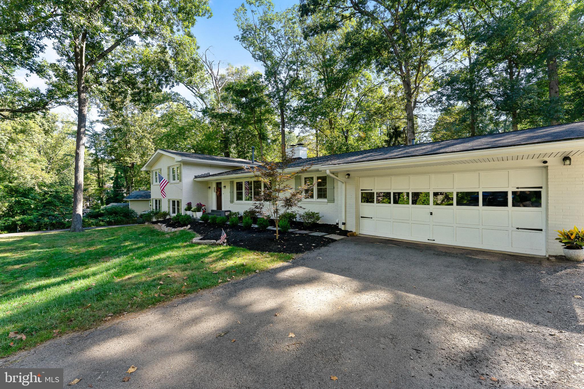 2425 Hunter Mill Road Vienna, VA 22181 - Photo 2 of 28 a front view of a house with a garden and trees