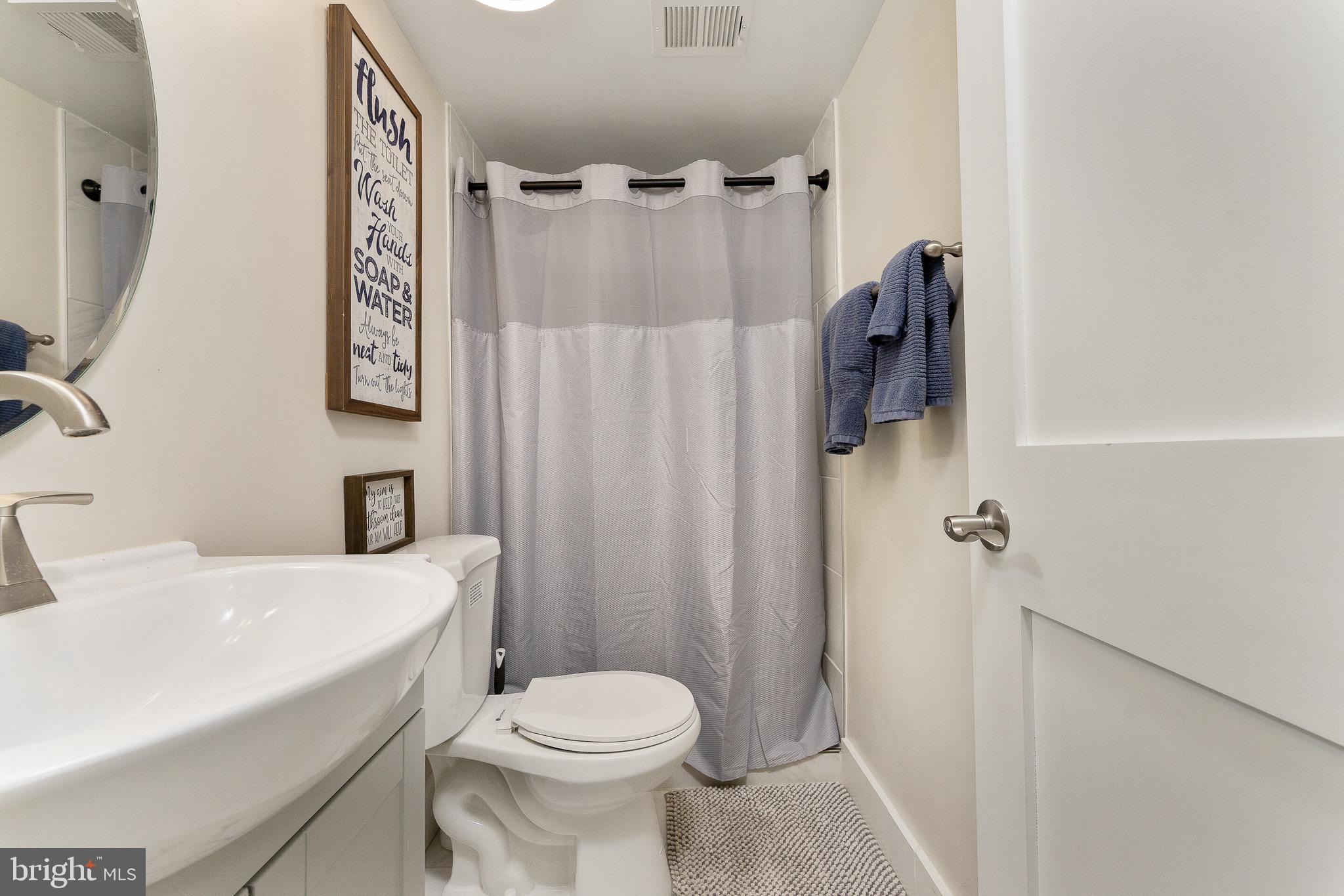 2425 Hunter Mill Road Vienna, VA 22181 - Photo 22 of 28 a bathroom with a sink toilet and shower