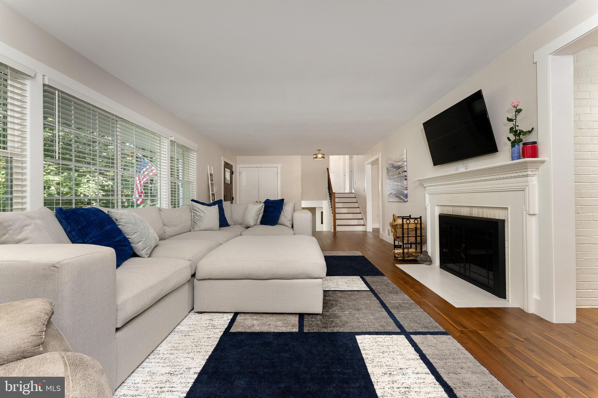2425 Hunter Mill Road Vienna, VA 22181 - Photo 4 of 28 a living room with furniture fireplace and flat screen tv