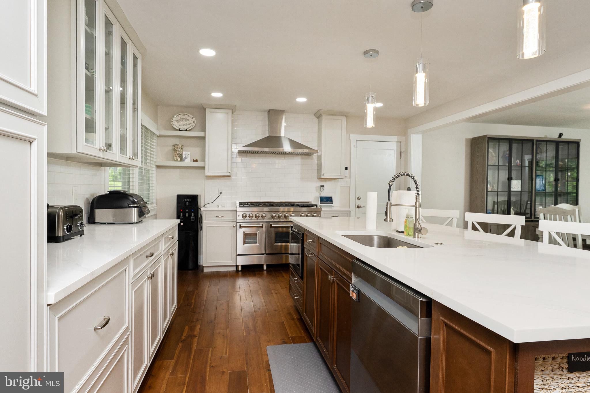 2425 Hunter Mill Road Vienna, VA 22181 - Photo 6 of 28 a kitchen with a sink a stove top oven a counter space and cabinets