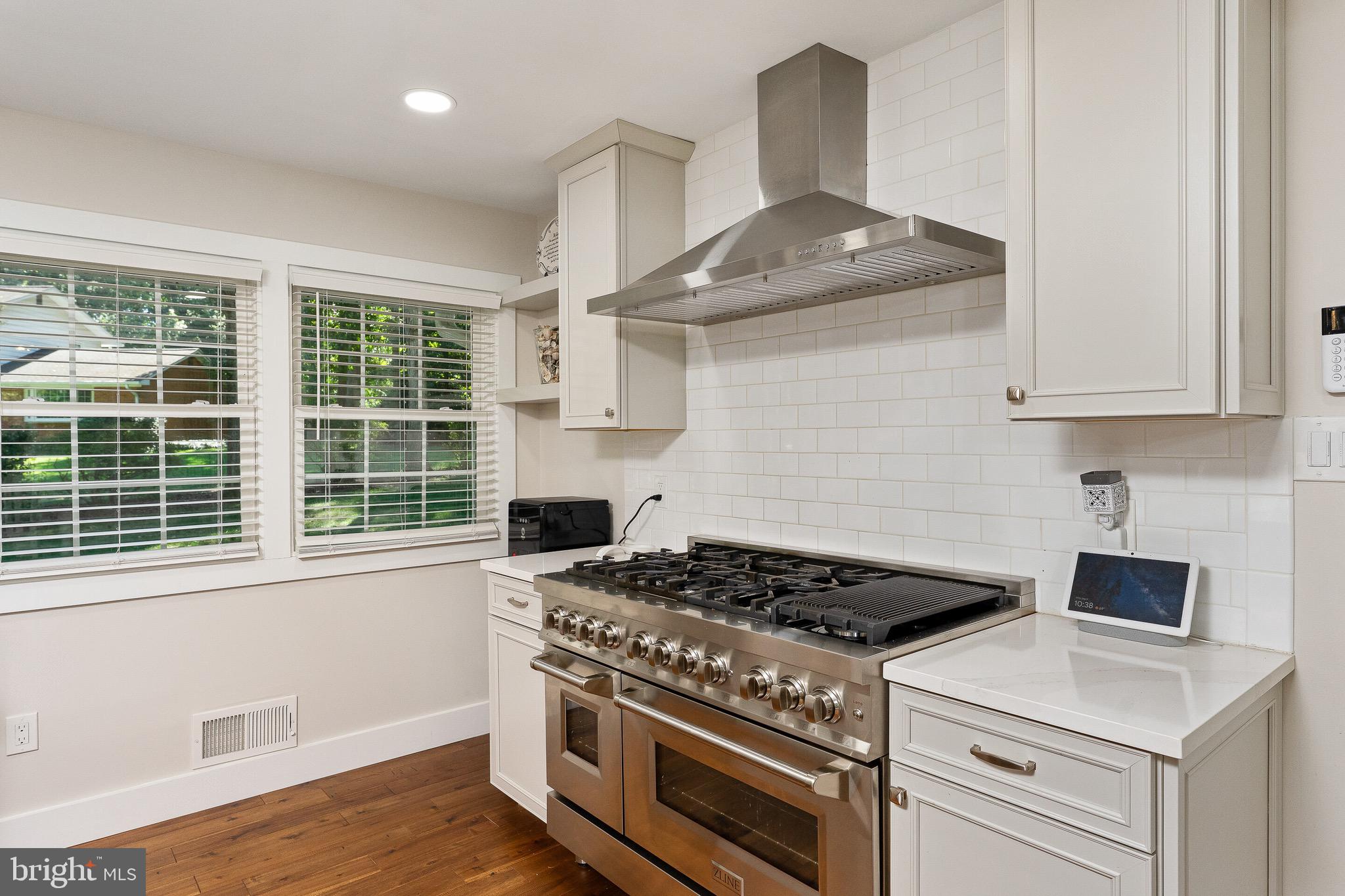 2425 Hunter Mill Road Vienna, VA 22181 - Photo 8 of 28 a kitchen with a stove and a white wooden cabinets