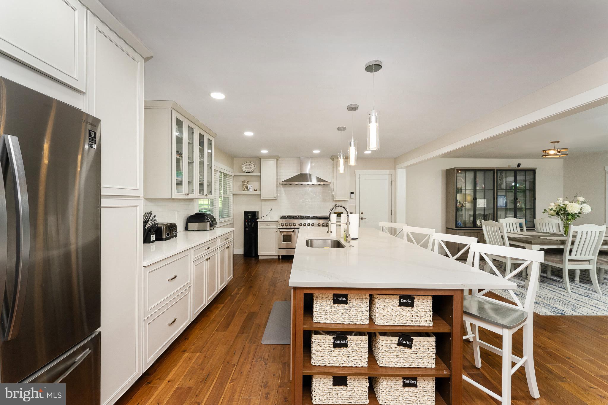 2425 Hunter Mill Road Vienna, VA 22181 - Photo 9 of 28 a kitchen with stainless steel appliances kitchen island granite countertop a table chairs and a refrigerator