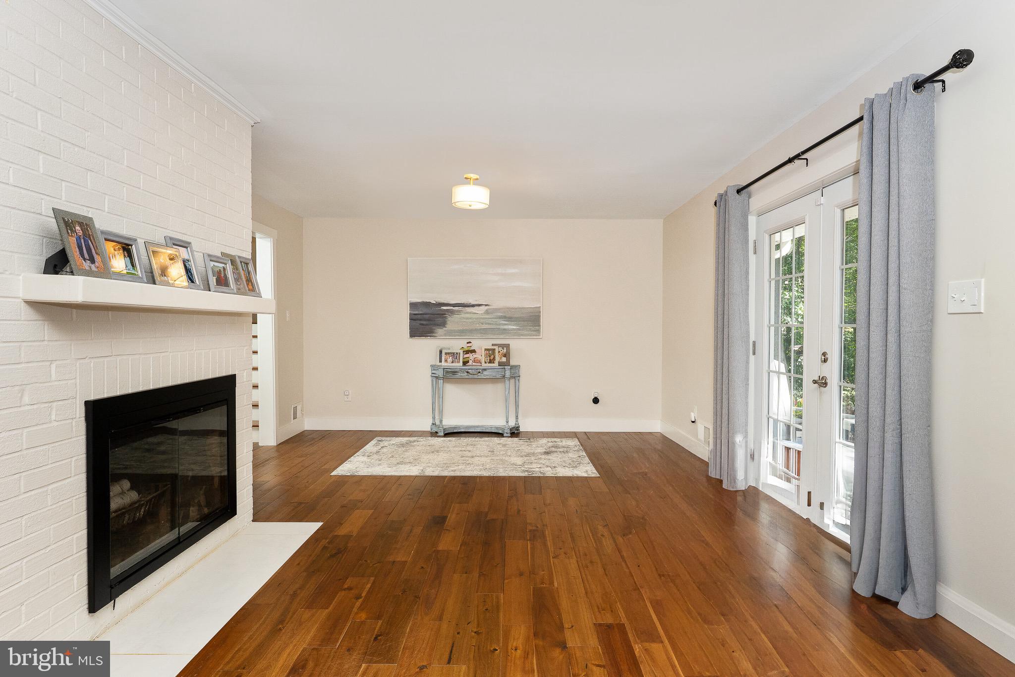 2425 Hunter Mill Road Vienna, VA 22181 - Photo 10 of 28 a view of a livingroom with wooden floor and a fireplace