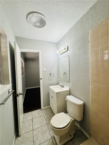 a bathroom with a toilet a sink and a mirror