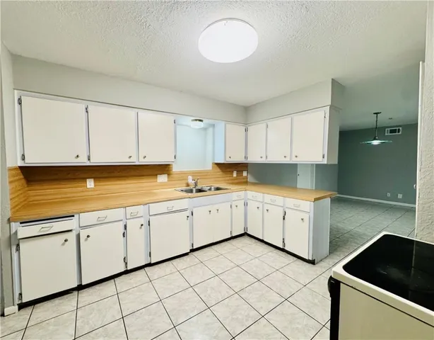 a kitchen with cabinets appliances and a sink