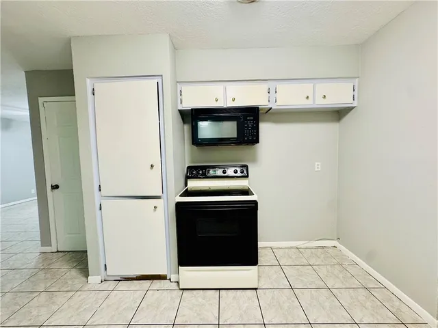 a kitchen with a stove and a refrigerator