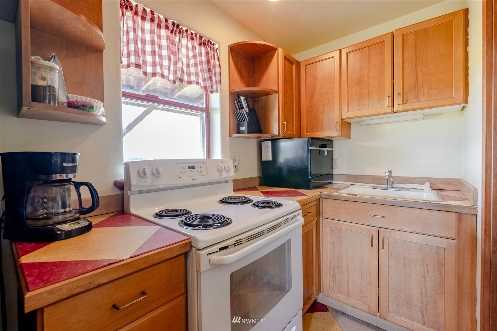 14202 Mima Road Southwest Olympia, WA 98512 - Photo 12 of 40 a kitchen with a sink stove and cabinets