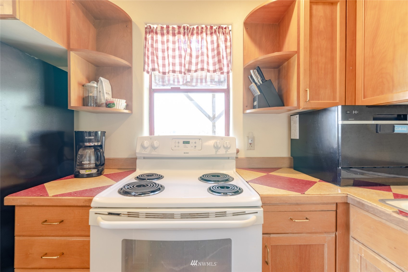 14202 Mima Road Southwest Olympia, WA 98512 - Photo 13 of 40 a kitchen with a stove a sink and a microwave