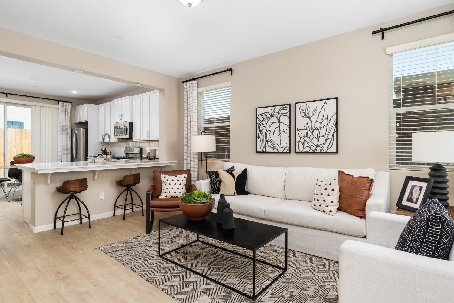 1116 Elevations Way West Madera, CA 93636 - Photo 4 of 20 a living room with furniture and a kitchen view