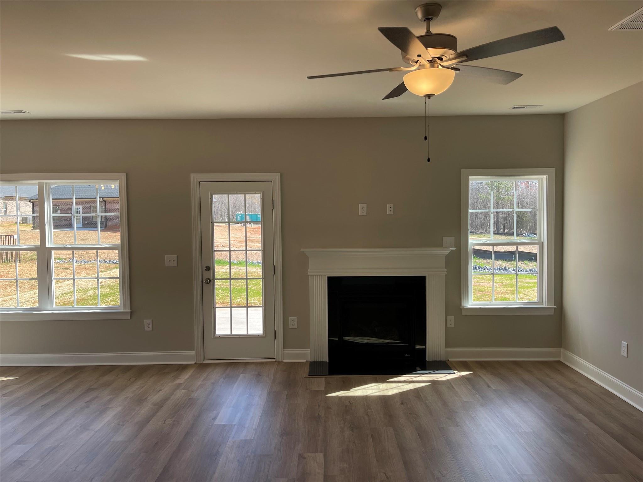 639 Church Street, Unit 99 Locust, NC 28097 - Photo 3 of 11 a view of an empty room with wooden floor fireplace and a window