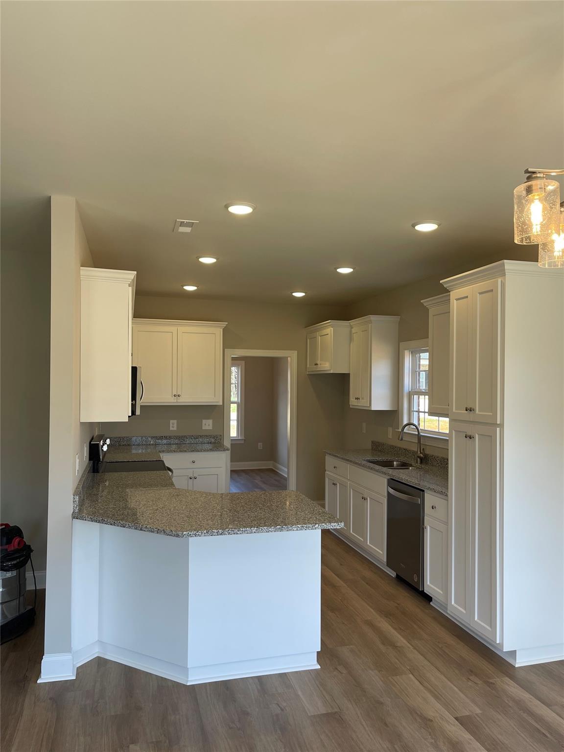 639 Church Street, Unit 99 Locust, NC 28097 - Photo 4 of 11 a kitchen with stainless steel appliances granite countertop a sink a stove and a refrigerator