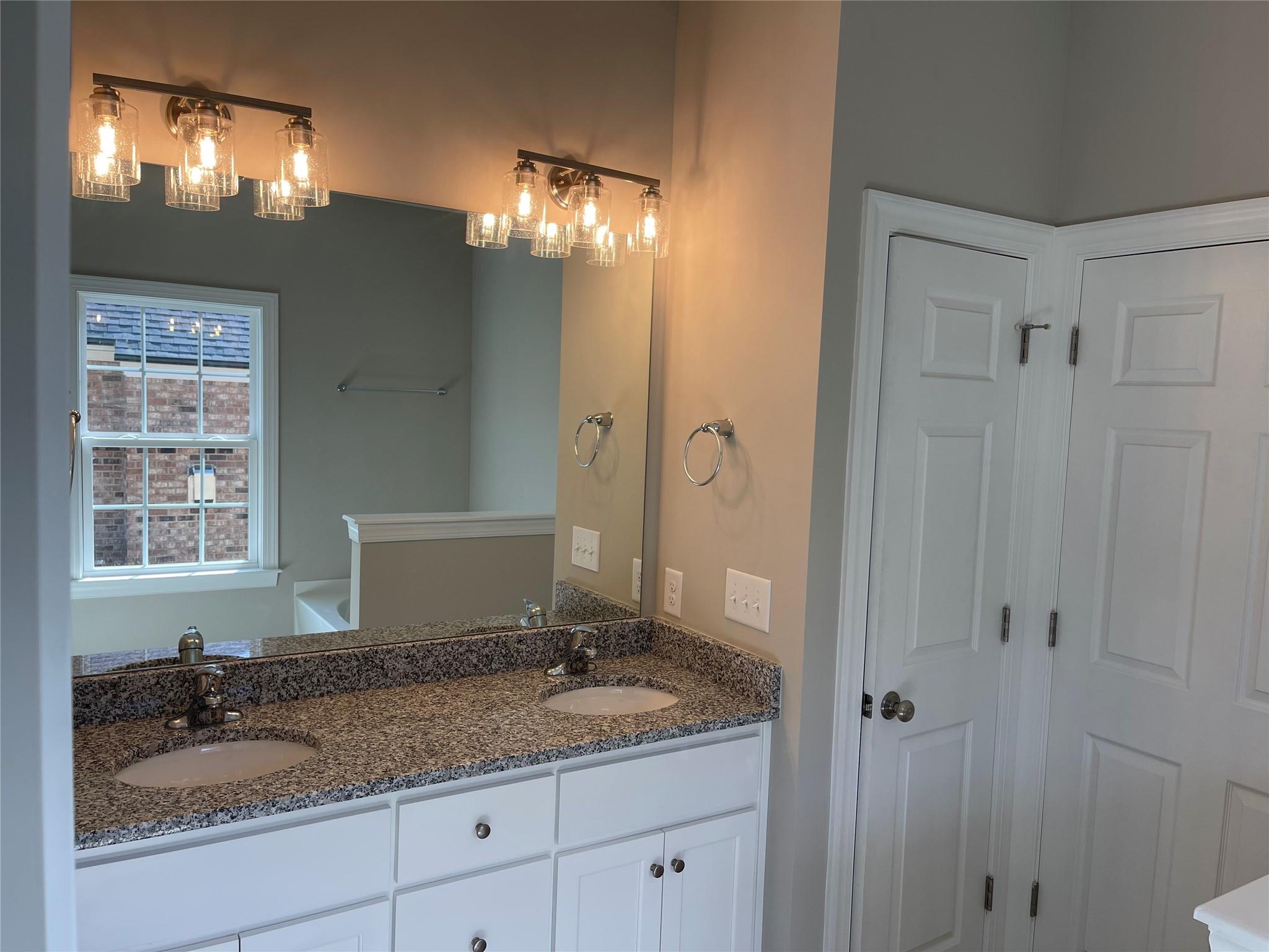 639 Church Street, Unit 99 Locust, NC 28097 - Photo 6 of 11 a bathroom with a granite countertop sink and a mirror