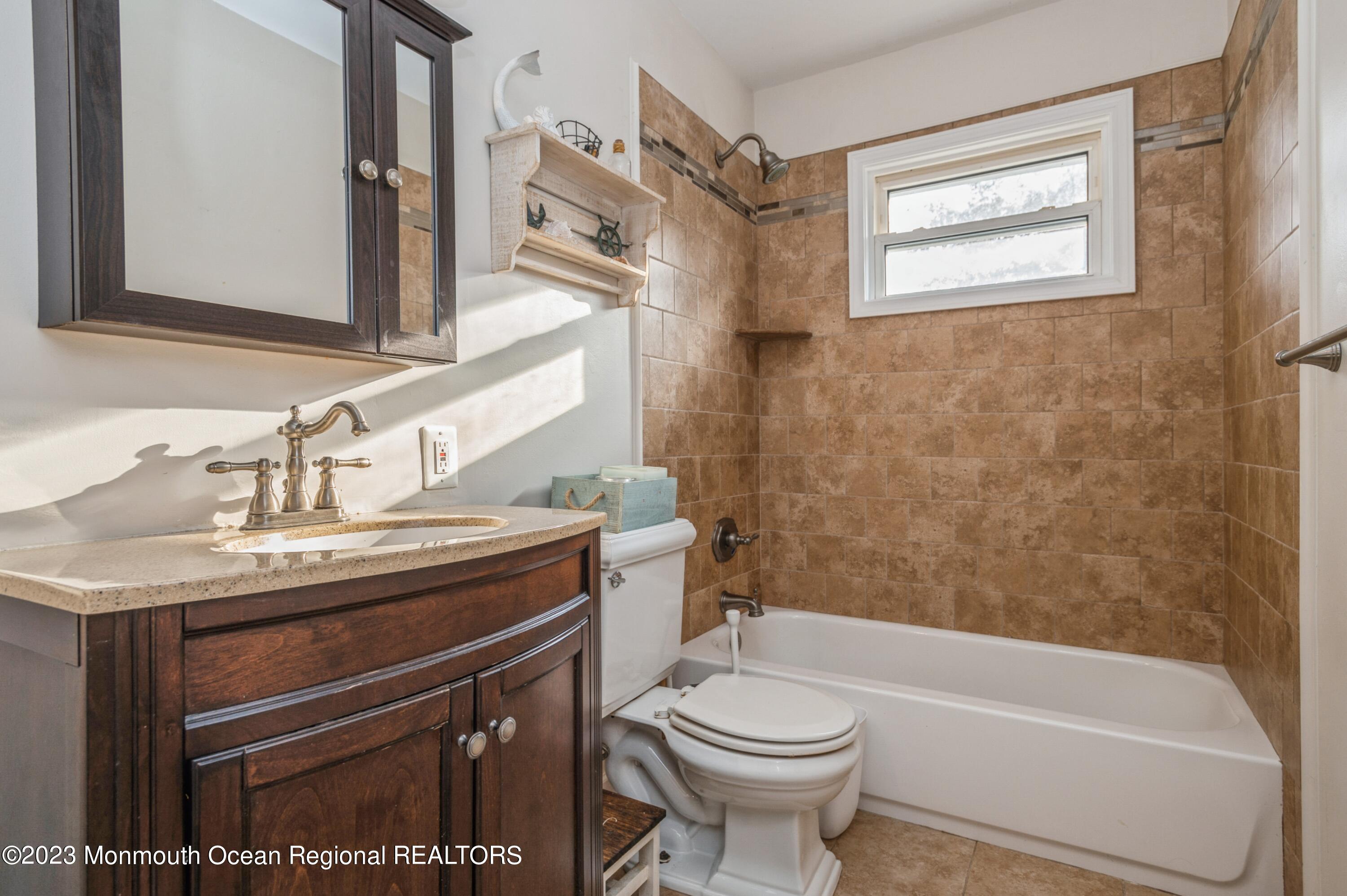 121 Darien Road Howell, NJ 07731 - Photo 13 of 19 a bathroom with a sink a toilet and a bathtub