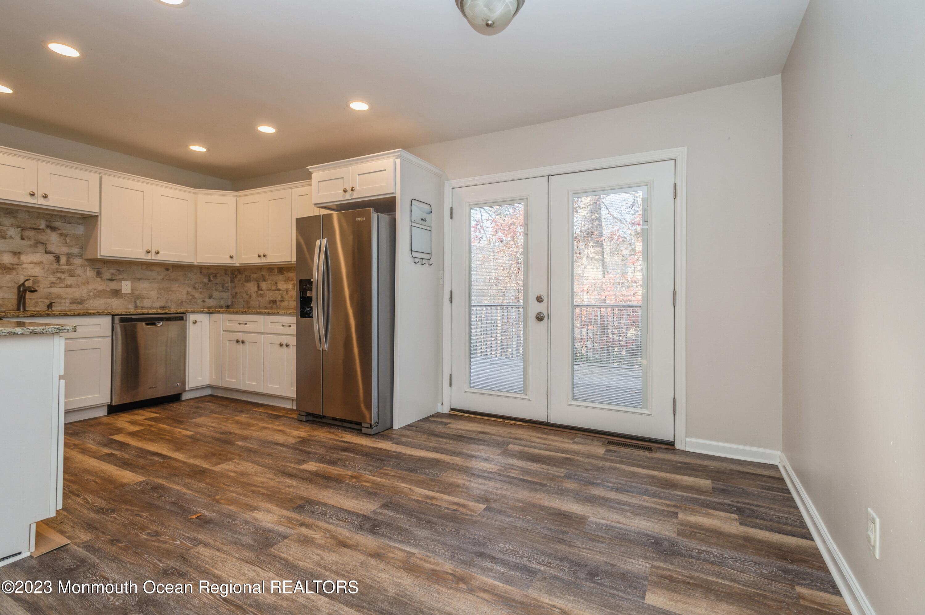 121 Darien Road Howell, NJ 07731 - Photo 4 of 19 a view of a kitchen with a refrigerator wooden cabinets and a sink