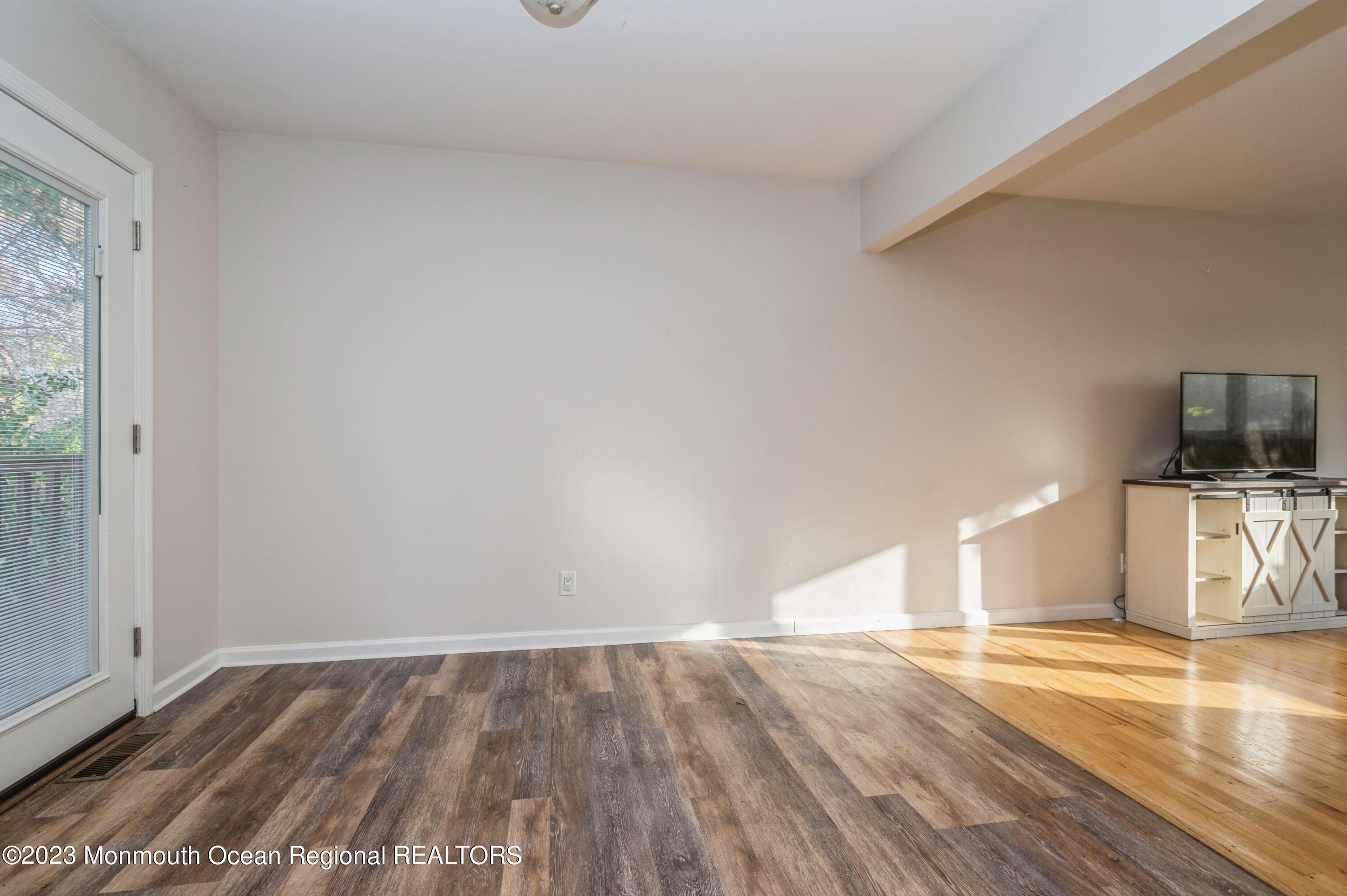121 Darien Road Howell, NJ 07731 - Photo 6 of 19 a view of empty room with wooden floor and fan