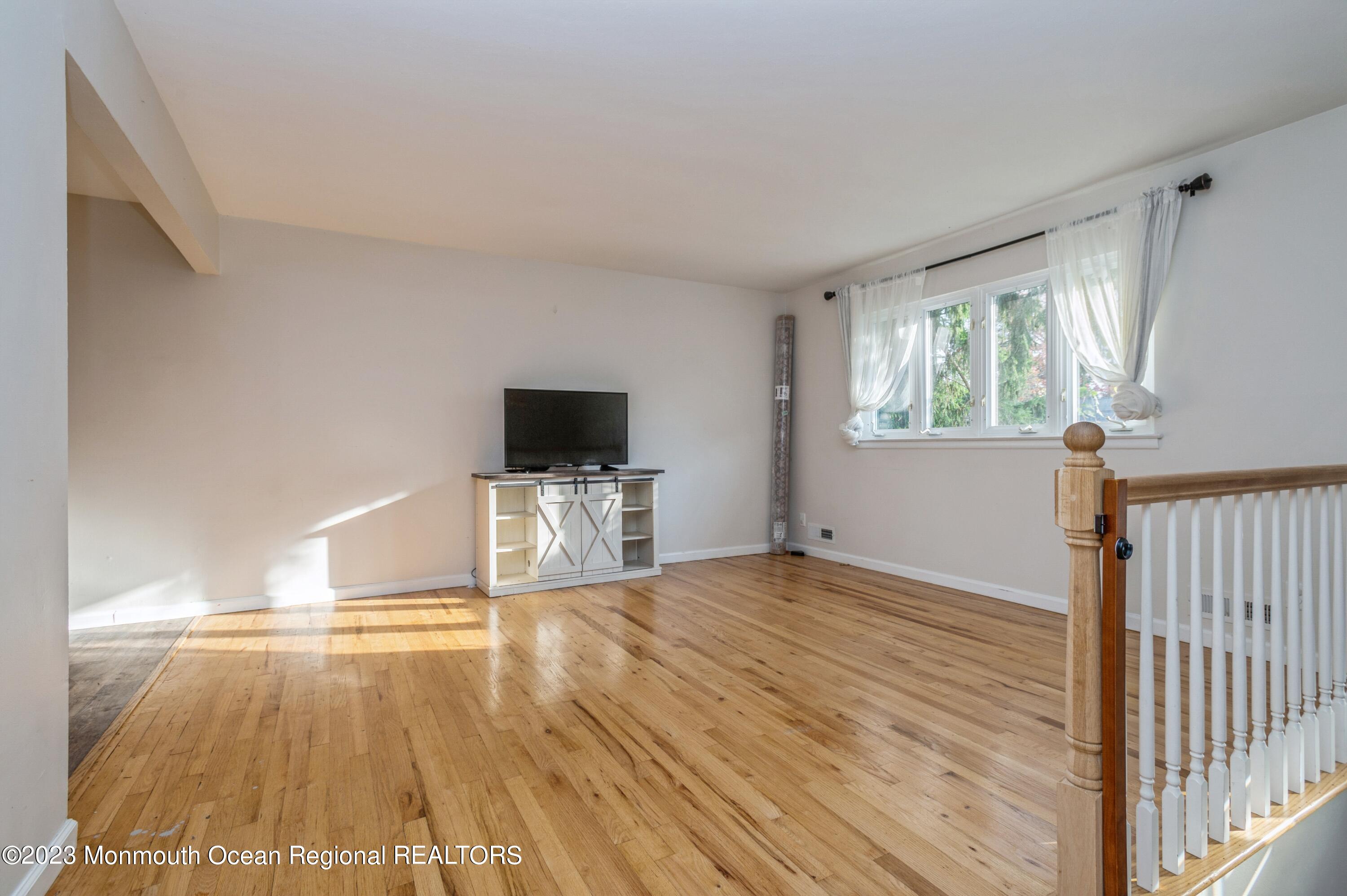 121 Darien Road Howell, NJ 07731 - Photo 7 of 19 a view of empty room with wooden floor and fan