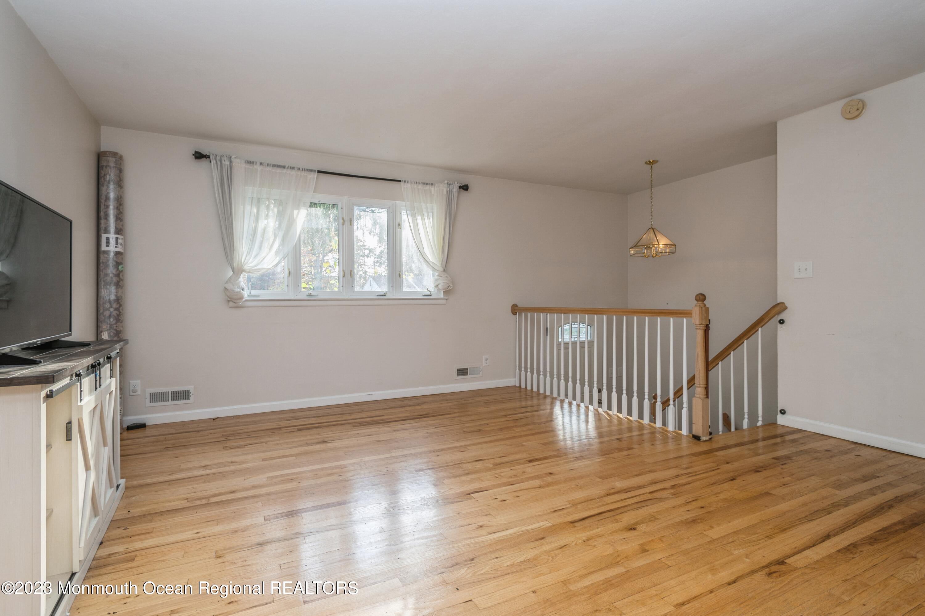 121 Darien Road Howell, NJ 07731 - Photo 8 of 19 a view of a livingroom with wooden floor and a flat screen tv